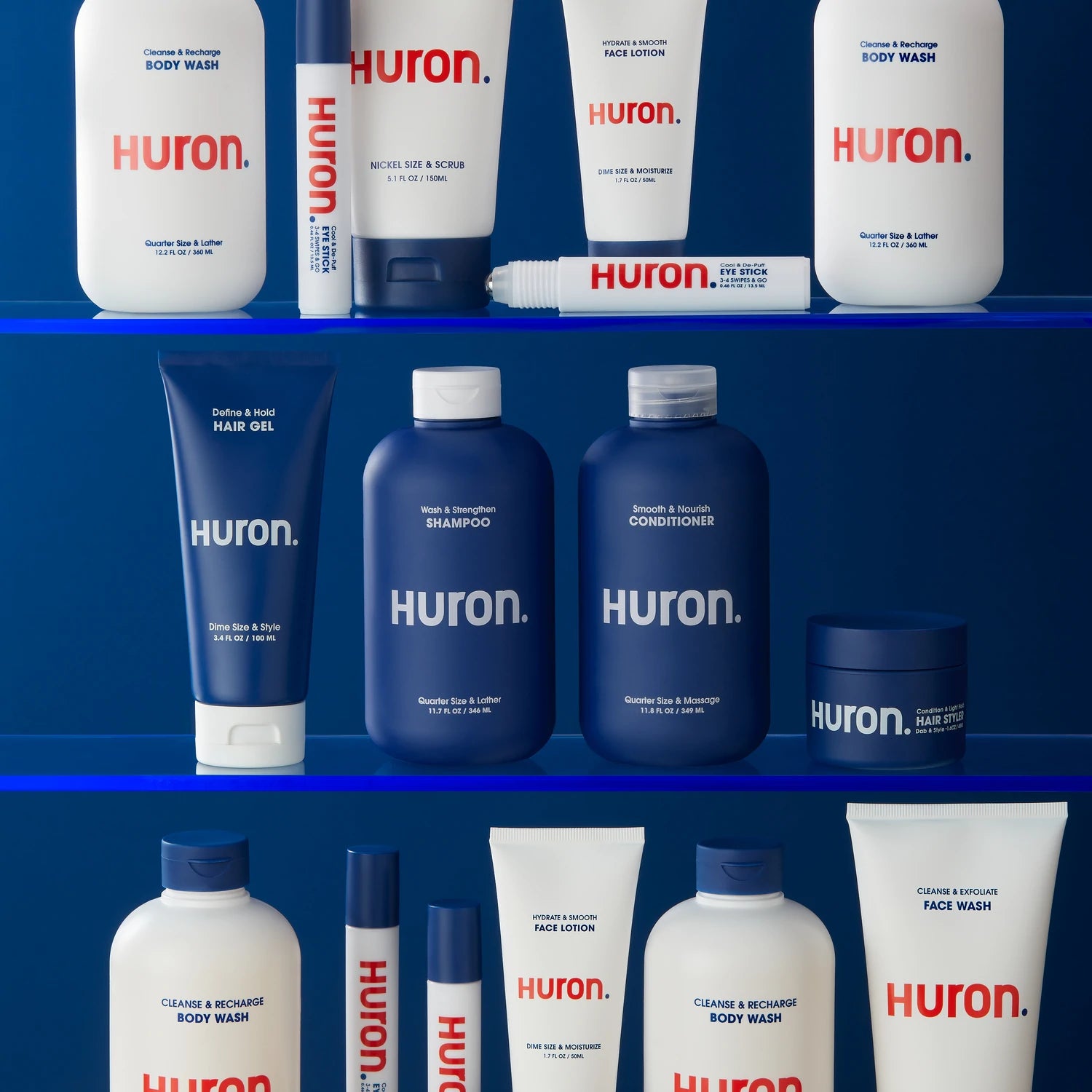 Skin care, hair care, and body care products sit on a shelf with a dark blue wall. 